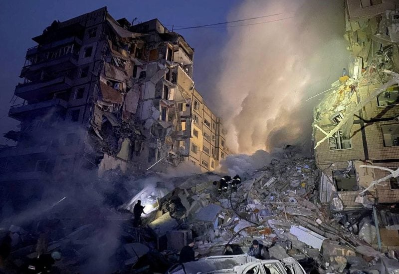 Rescuers work at the site where an apartment building was heavily damaged by a Russian missile strike, amid Russia's attack on Ukraine, in Dnipro, Ukraine January 14, 2023. Press service of the State Emergency Service of Ukraine/Handout via REUTERS
