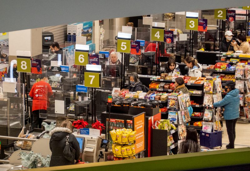 People pay for their items at a grocery store in Toronto, Ontario, Canada November 22, 2022. REUTERS