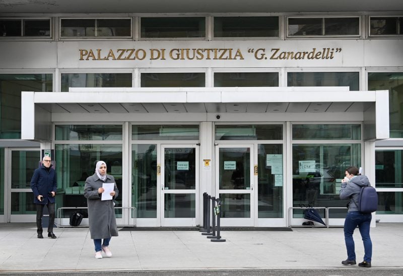 People are seen in front of the courthouse of Brescia ahead of a hearing to decide whether to hand over Maria Dolores Colleoni, wife of former MEP Antonio Panzeri who was arrested in Brussels on charges of corruption in the European Parliament for the benefit of Qatar and Morocco, to the Belgian authorities, in Brescia, Italy December 19, 2022. REUTERS/Flavio Lo Scalzo