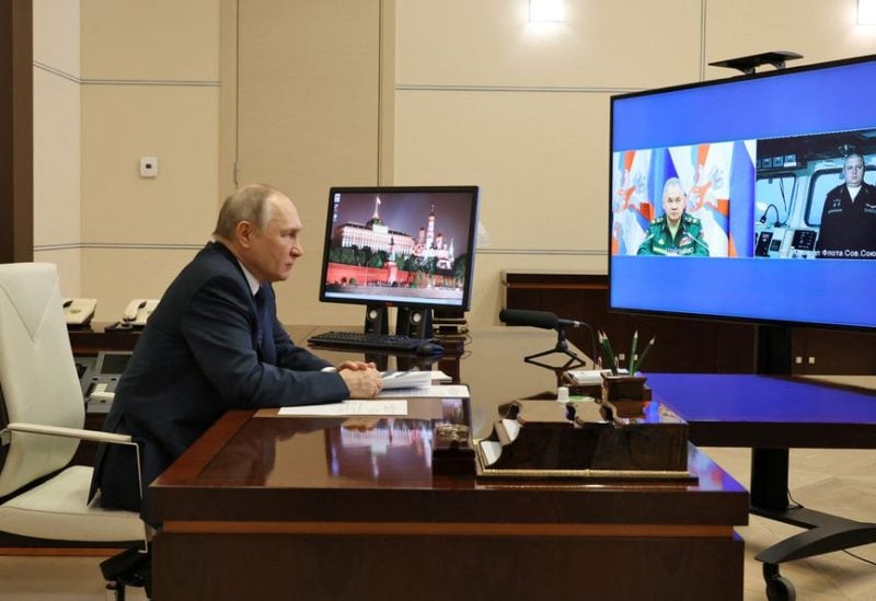 Russian President Vladimir Putin listens to the report by Defence Minister Sergei Shoigu and Commander of the Admiral Gorshkov frigate Igor Krokhmal before a ceremony to launch the Admiral Gorshkov frigate to the combat mission, via video link in Moscow, Russia January 4, 2023. Sputnik/Mikhail Klimentyev/Kremlin via REUTERS