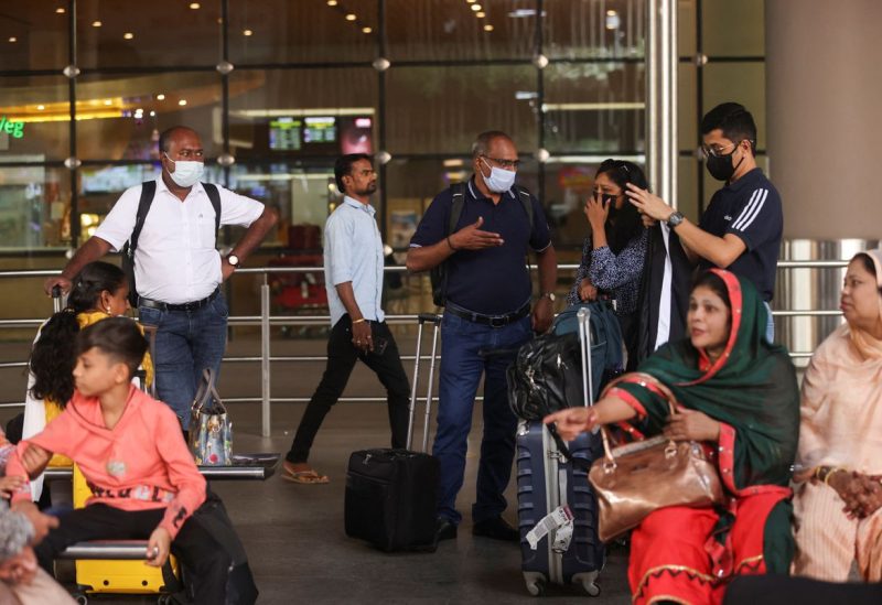 Passengers wait with their luggage at the Chhatrapati Shivaji Maharaj International Airport in Mumbai, India, December 22, 2022. REUTERS/Francis Mascarenhas
