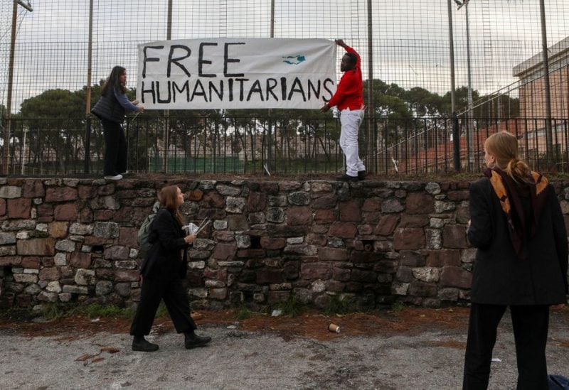 Supporters hang a banner outside a courthouse as aid worker face trial over refugee rescues, on the island of Lesbos, Greece, January 13, 2023. REUTERS