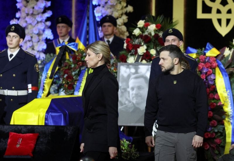 Ukraine's President Volodymyr Zelenskiy and first lady Olena Zelenska attend a memorial ceremony for Ukrainian Interior Minister Denys Monastyrskyi, his deputy and officials who died in the helicopter crash near Kyiv, in Kyiv, Ukraine, January 21, 2023 - REUTERS