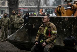 An emergency worker rests at the site where an apartment block was heavily damaged by a Russian missile strike, amid Russia's attack on Ukraine, in Dnipro, Ukraine January 15, 2023. REUTERS/Yevhenii Zavhorodnii