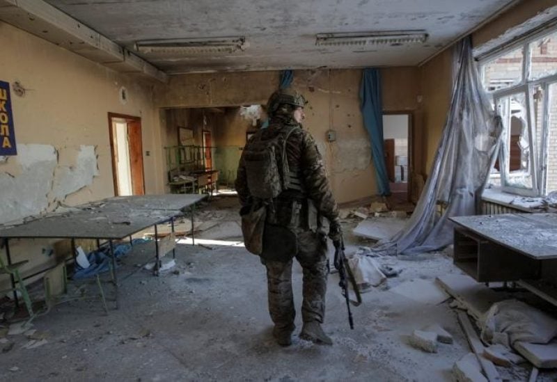 A Ukrainian serviceman is seen in a destroyed building of a school at a frontline, amid Russia's attack on Ukraine, in Donetsk region, Ukraine January 7, 2023.