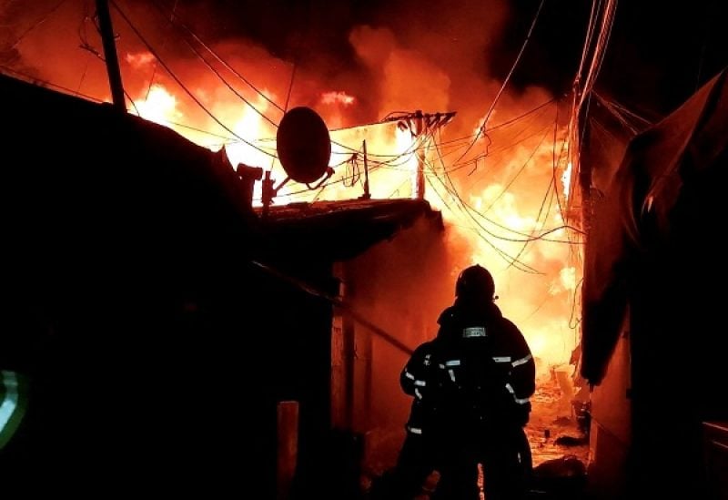 Firefighters work to put out the fire at Guryong village, the last slum in Seoul's glitzy Gangnam district in Seoul, South Korea, January 20, 2023. South Korea's National Fire Agency/Yonhap via REUTERS ATTENTION EDITORS - THIS IMAGE HAS BEEN SUPPLIED BY A THIRD PARTY. SOUTH KOREA OUT. NO RESALES. NO ARCHIVE