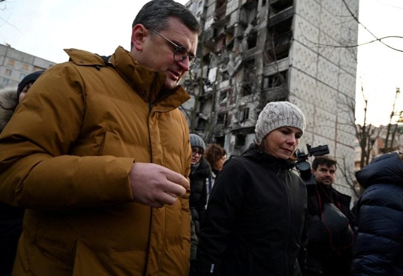 German Foreign Minister Annalena Baerbock and Ukrainian Foreign Minister Dmytro Kuleba visit a residential area damaged by Russian military strikes, amid Russia's attack on Ukraine, in Kharkiv, Ukraine January 10, 2023. Press Service of the Ministry of Foreign Affairs of Ukraine/Handout via REUTERS ATTENTION EDITORS - THIS IMAGE HAS BEEN SUPPLIED BY A THIRD PARTY.