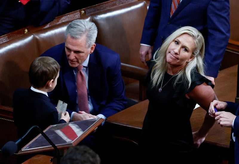 House Republican leader Kevin McCarthy (R-CA) talks with a young boy brought to meet him by Rep. Marjorie Taylor Greene (R-GA) just before the start of a second round of voting in the race to be the next Speaker of the House in the House Chamber on the first day of the 118th Congress at the U.S. Capitol in Washington, U.S., January 3, 2023. REUTERS/Evelyn Hockstein