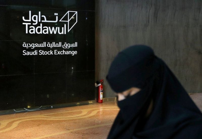 A Saudi woman walks at the Saudi stock market (Tadawul), in Riyadh, Saudi Arabia March 9, 2020. REUTERS