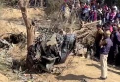 People gather around the debris of a crashed aircraft in Bharatpur, Rajasthan, India, January 28, 2023 in this screen grab obtained from a handout video. ANI/Handout via REUTERS THIS IMAGE HAS BEEN SUPPLIED BY A THIRD PARTY. INDIA OUT. NO COMMERCIAL OR EDITORIAL SALES IN INDIA.
