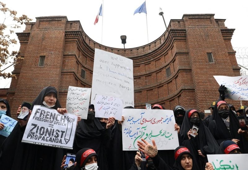 Demonstrators take part in a protest to condemn the French magazine Charlie Hebdo for republishing cartoons insulting Iran's Supreme Leader Ayatollah Ali Khamenei, in front of the French Embassy in Tehran, Iran, January 11, 2023. Majid Asgaripour/WANA (West Asia News Agency) via REUTERS ATTENTION EDITORS - THIS PICTURE WAS PROVIDED BY A THIRD PARTY.