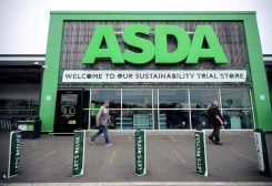 Shoppers walk past the UK supermarket Asda, in Leeds, Britain, October 19, 2020. REUTERS