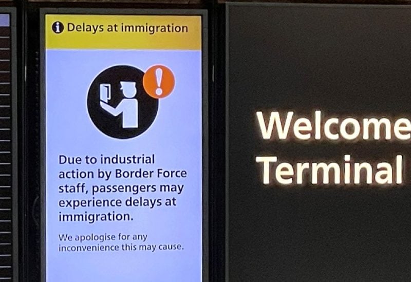 An arrivals board displays a message warning users of terminal 5 about industrial action by Border Force staff, at Heathrow Airport, near London, Britain, December 23, 2022. REUTERS/Peter Nicholls