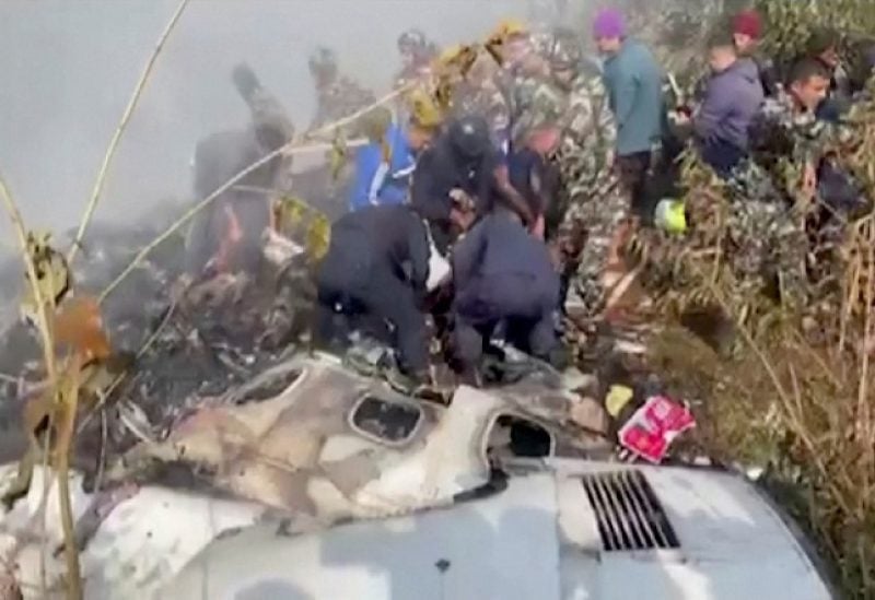 Rescuers work at the site of a plane crash in Pokhara, Nepal January 15, 2023, in this screen grab taken from a handout video. ANI/Handout/via REUTERS ATTENTION EDITORS - THIS IMAGE HAS BEEN SUPPLIED BY A THIRD PARTY. INDIA OUT. NO COMMERCIAL OR EDITORIAL SALES IN INDIA