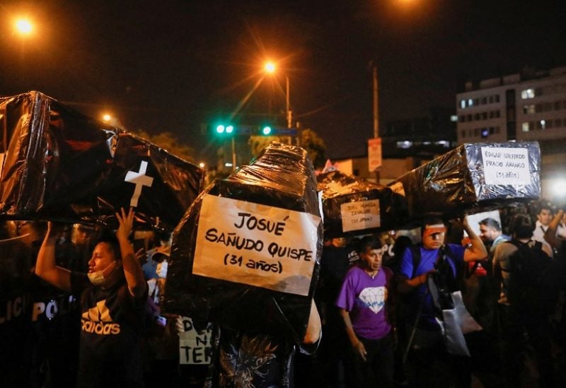 FILE PHOTO: Demonstrators carry mockup coffins during a protest to demand the dissolution of Congress and democratic elections, rejecting Dina Boluarte as Peru's president, after the ouster of leftist President Pedro Castillo, in Lima, Peru January 12, 2023. REUTERS/Alessandro Cinque/File Photo