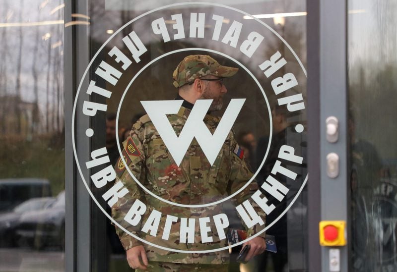 A man wearing a camouflage uniform walks out of PMC Wagner Centre, which is a project implemented by the businessman and founder of the Wagner private military group Yevgeny Prigozhin, during the official opening of the office block in Saint Petersburg, Russia, November 4, 2022. REUTERS/Igor Russak