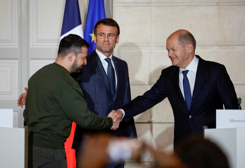 Ukraine's President Volodymyr Zelenskiy and German Chancellor Olaf Scholz shake hands during a joint statement with French President Emmanuel Macron, at the Elysee Palace in Paris, France, February 8, 2023. REUTERS/Sarah Meyssonnier/Pool