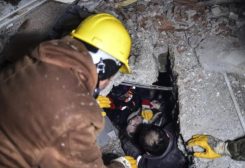 Emergency workers and medics rescue a woman out of the debris of a collapsed building in Elbistan, Kahramanmaras, in southern Türkiye, Tuesday, Feb. 7, 2023. (Ismail Coskun/IHA via AP)