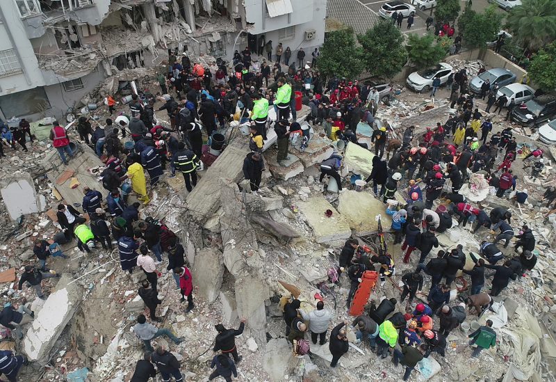 People search through rubble following an earthquake in Adana, Turkey February 6, 2023. Ihlas News Agency (IHA) via REUTERS