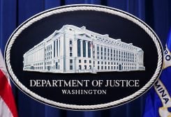 A U.S. Justice Department logo or seal showing Justice Department headquarters, known as "Main Justice," is seen behind the podium in the Department's headquarters briefing room before a news conference with the Attorney General in Washington, January 24, 2023. REUTERS/Kevin Lamarque