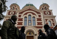 Ukrainian law enforcement officers stand next to St. George's Cathedral of the Ukrainian Orthodox Church branch loyal to Moscow, in Lviv, Ukraine, December 14, 2022. REUTERS