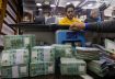 A man counts Lebanese pound banknotes at an exchange shop in Beirut, Lebanon, January 11, 2023. REUTERS/Mohamed Azakir