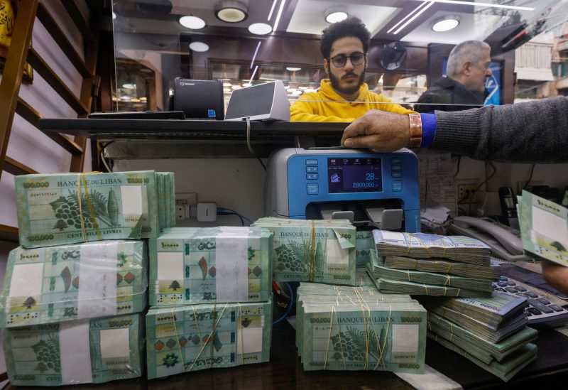 A man counts Lebanese pound banknotes at an exchange shop in Beirut, Lebanon, January 11, 2023. REUTERS/Mohamed Azakir