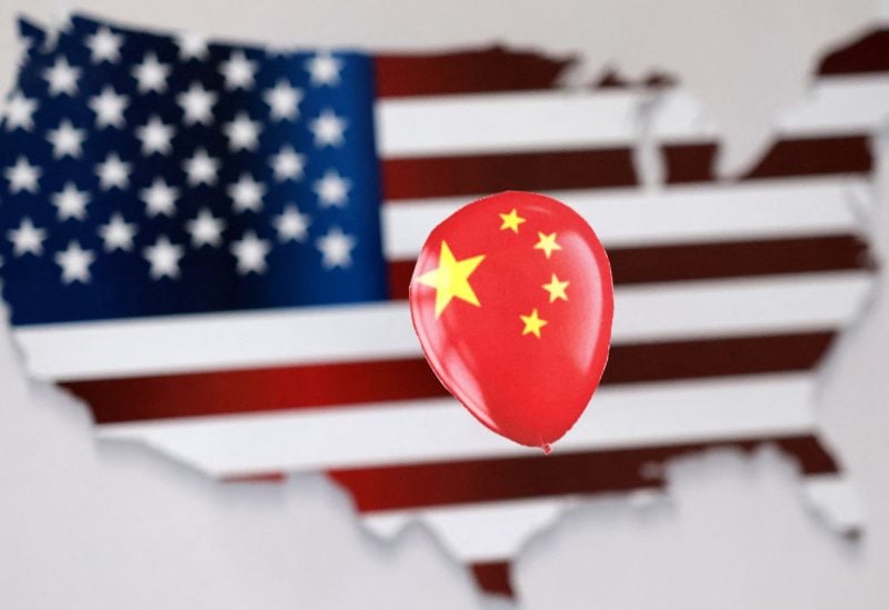 A printed balloon with Chinese flag is placed on a U.S. flag in the shape of U.S. map outline, in this illustration taken February 5, 2023. REUTERS/Dado Ruvic/Illustration