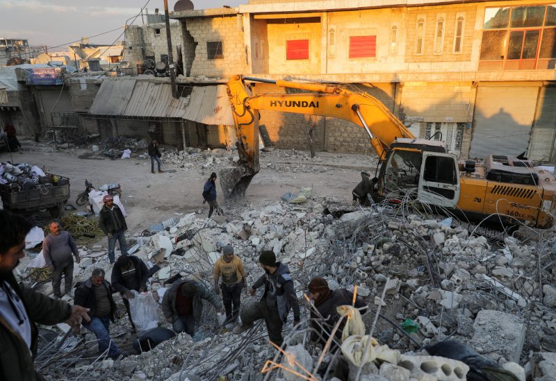 People search under the rubble of a damaged building, in the aftermath of an earthquake, in rebel-held town of Jandaris, Syria February 15, 2023. REUTERS/Khalil Ashawi