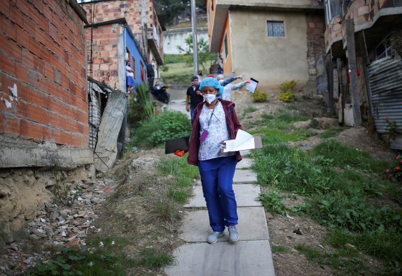 Mayoral employees walk through a poor neighborhood during a day of food aid delivery, amid the outbreak of the coronavirus disease (COVID-19) in Bogota, Colombia April 21, 2020. REUTERS/Luisa Gonzalez