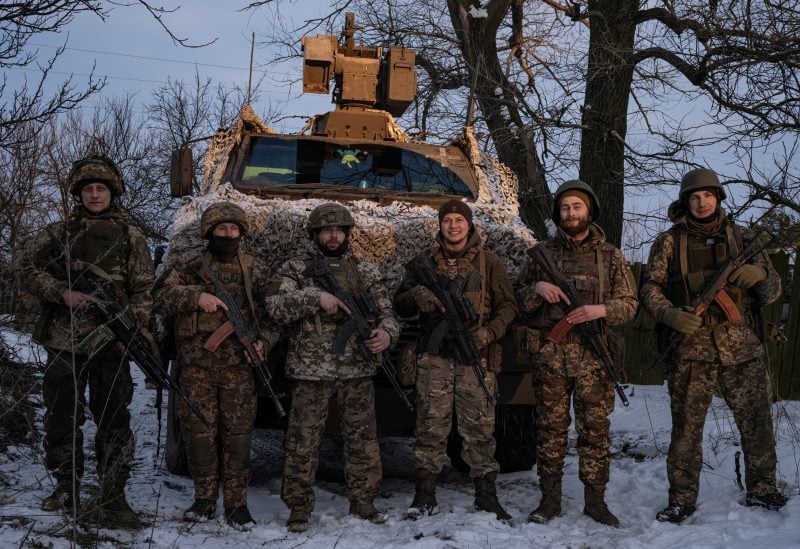 Ukrainian servicemen of the 80th Air Assault Brigade stand in front of a Bushmaster Protected Mobility Vehicle, amid Russia's attack on Ukraine, near Bahmut, Donetsk region, Ukraine, February 16, 2023. REUTERS/Marko Djurica