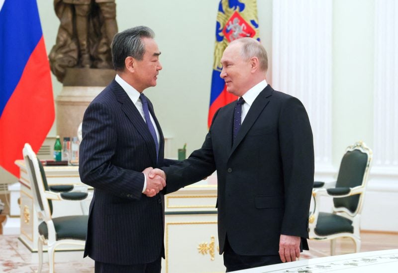 Russia's President Vladimir Putin shakes hands with China's Director of the Office of the Central Foreign Affairs Commission Wang Yi during a meeting in Moscow, Russia February 22, 2023. Sputnik/Anton Novoderezhkin/Pool via REUTERS