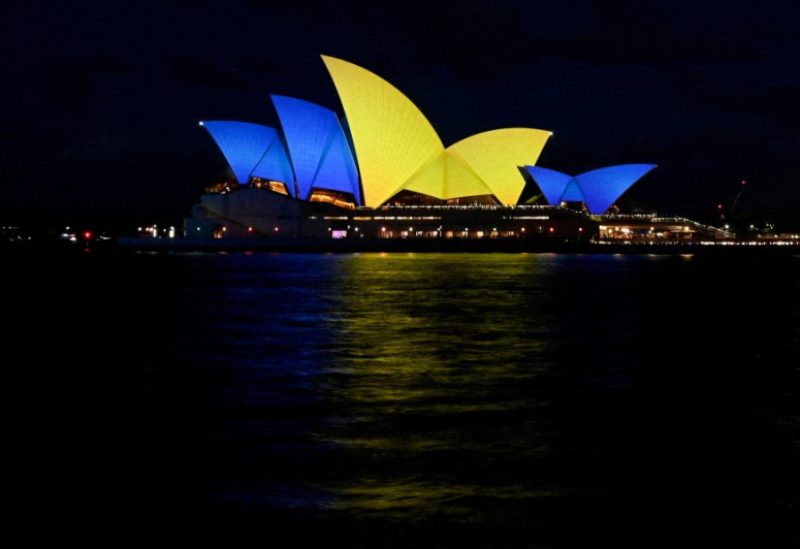 The sails of the Sydney Opera House get illuminated with the colours of the Ukrainian Flag to mark one year since Russia's invasion of Ukraine began, in Sydney, Australia, February 24, 2023. REUTERS Jaimi Joy