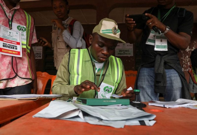 A member of the National Youth Service Corps (NYSC) operates a Bimodal Voter Accreditation System (BVAS) during Nigeria's Presidential election in Agulu, Anambra state, Nigeria February 25, 2023 - REUTERS