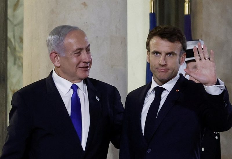 French President Emmanuel Macron welcomes Israeli Prime Minister Benjamin Netanyahu as he arrives for a dinner at the Elysee Palace, in Paris, France, February 2, 2023. REUTERS/Benoit Tessier