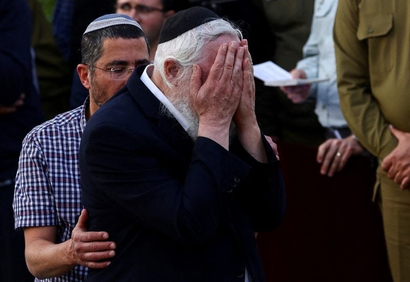 A mourner reacts during the funeral of Hillel Yaniv and Yigal Yaniv, Israeli brothers from the Har Bracha settlement, who were killed by a suspected Palestinian gunman as they were driving in the occupied West Bank, at the Mount Herzl military cemetery in Jerusalem, February 27, 2023. REUTERS/Ronen Zvulun TPX IMAGES OF THE DAY