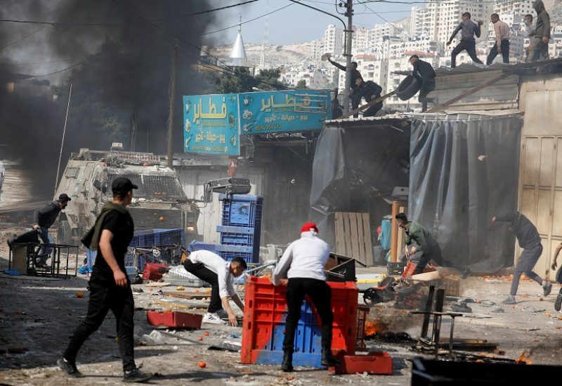 Palestinians clash with Israeli forces during a raid in Nablus in the Israeli-occupied West bank, February 22, 2023. REUTERS/Raneen Sawafta