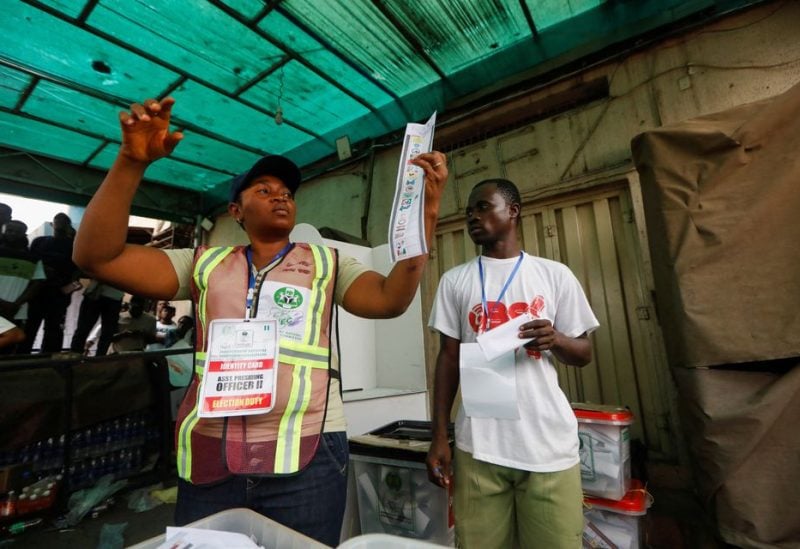 A poll worker holds up a ballot paper during the counting process of Nigeria's presidential election, at a polling unit in Awka, Anambra state, Nigeria February 25, 2023. REUTERS