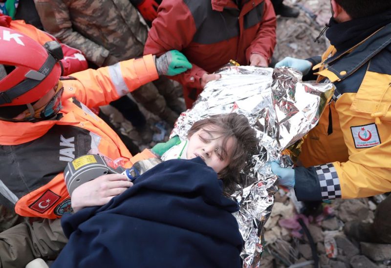 Turkish boy Poyraz is carried to an ambulance after being rescued alive from rubbles in the aftermath of a deadly earthquake in Kahramanmaras, Turkey February 10, 2023 - REUTERS
