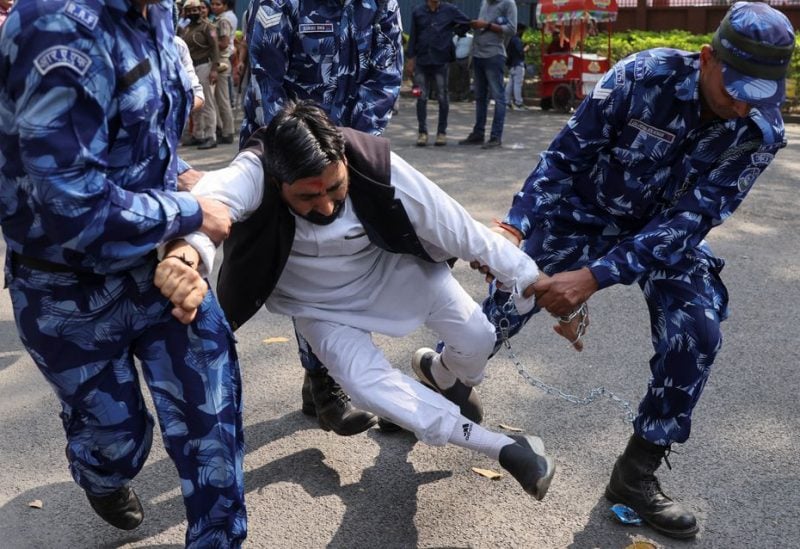 Members of Rapid Action Force detain a supporter of Aam Aadmi Party (AAP) during a protest against the arrest of Delhi's Deputy Chief Minister Manish Sisodia in New Delhi, India, February 27, 2023 - REUTERS