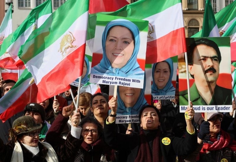 People hold Iranian flags and portraits of Iranian opposition leader Maryam Rajavi during a protest on the day of the Munich Security Conference, in Munich, Germany February 17, 2023. REUTERS/Wolfgang Rattay