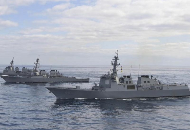 In this photo provided by South Korea Defense Ministry, South Korean Navy's Aegis destroyer King Sejong the Great, front, sails with US Navy's Arleigh Burke-class guided-missile destroyer USS Barry, center, and Japan Maritime Self-Defense Force's destroyer Atago, top, during a joint missile defense drill between South Korea, the United States and Japan in the international waters of the east coast of Korean peninsular, Wednesday, Feb. 22, 2023. (South Korea Defense Ministry via AP)