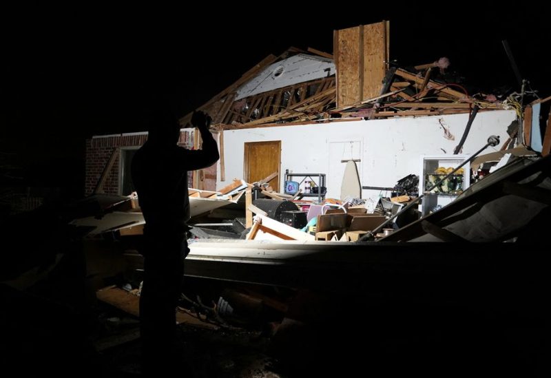 Chandler Browning looks over his in-laws home that was destroyed by a tornado after a tornado in Norman, Oklahoma, U.S. February 27, 2023. REUTERS