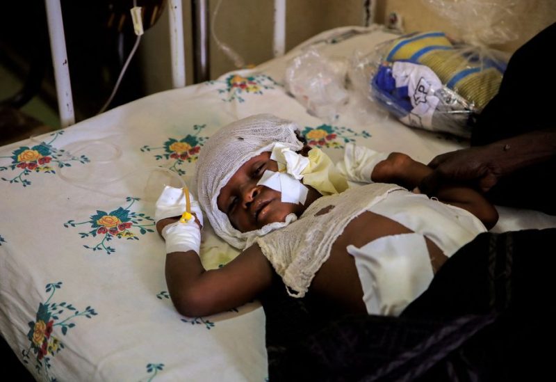 Dawud Ali, 8, sleeps next to his uncle, Mohammed Ali, 40, after losing fingers from explosives that were left close to his house in the aftermath of fighting between the Ethiopian National Defense Force (ENDF) and the Tigray People's Liberation Front (TPLF) forces - REUTERS