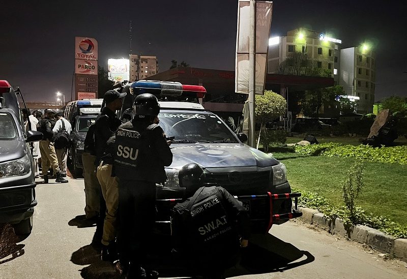 Police officers take position after a police office building was attacked by gunmen in Karachi, Pakistan February 17, 2023. REUTERS/Akhtar Soomro