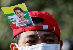 A Myanmar protester residing in Japan uses a flag with an image of deposed Myanmar leader Aung San Suu Kyi during a rally to mark the second anniversary of Myanmar's 2021 military coup, outside the Embassy of Myanmar in Tokyo, Japan February 1, 2023. REUTERS/Issei Kato
