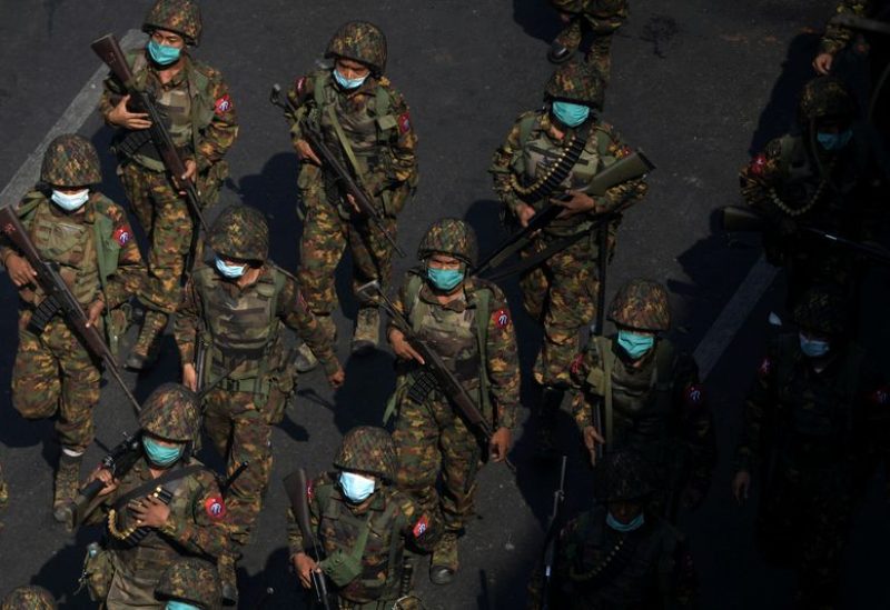 Myanmar soldiers from the 77th light infantry division walk along a street during a protest against the military coup in Yangon, Myanmar, February 28, 2021. REUTERS/Stringer