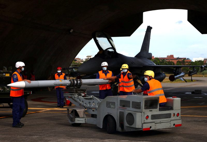 Air force soldiers load a U.S. made AIM-120 Advanced Medium-Range Air-to-Air Missile at a combat readiness mission during a press invited event at the airbase in Hualien, Taiwan, August 17, 2022. REUTERS/Ann Wang