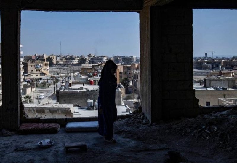 A displaced Syrian woman living in war-damaged buildings, are pictured in Syria's opposition-held northern city of Raqqa on March 1, 2023, amid fears that the already fragile dwellings will not withstand an earthquake.(AFP)