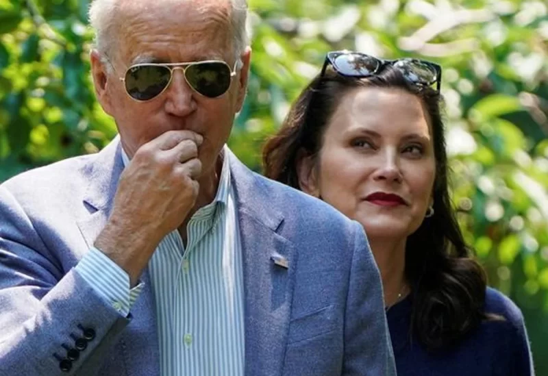 U.S. President Joe Biden eats a cherry as he tours King Orchards with Michigan Governor Gretchen Whitmer in Central Lake, Michigan, U.S., July 3, 2021. REUTERS/Joshua Roberts